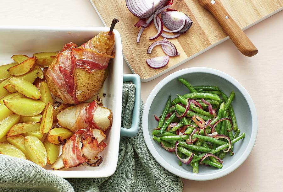 Bacon-wrapped Pears With Roast Potatoes And A Bean And Onion Salad Photograph by Misha Vetter