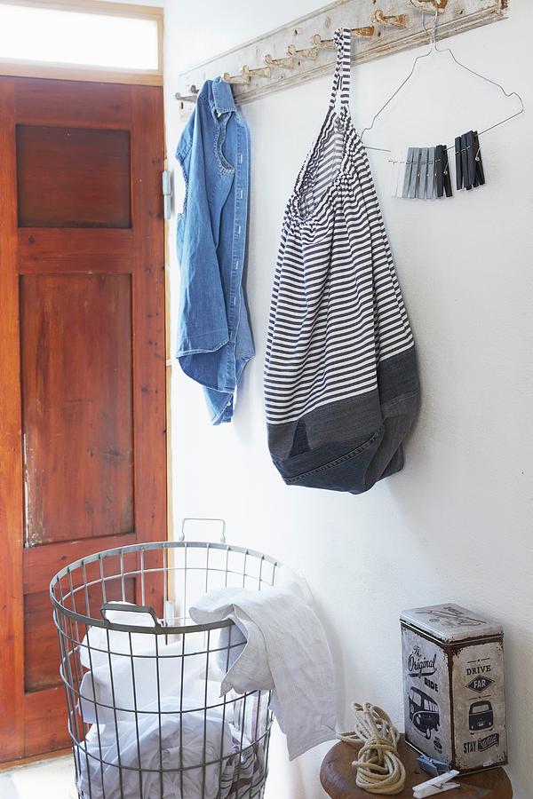 Bag Made From Striped Fabric And Old Denim Hung From Coat Rack Photograph by Greenhaus Press