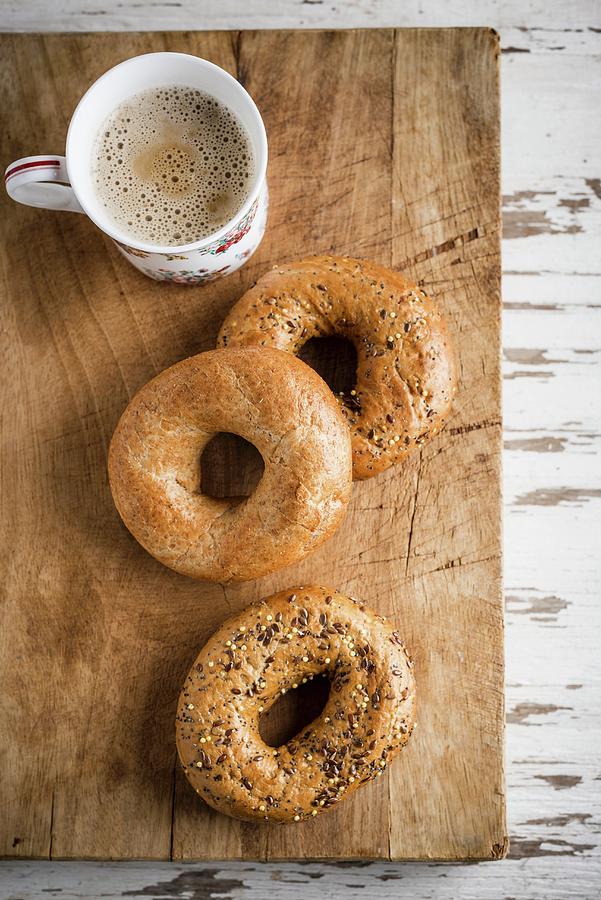 Bagels And Coffee On A Chopping Board Photograph by Nitin Kapoor