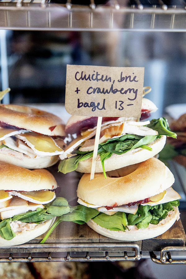 Bagels With Chicken Breast, Brie Cheese And Cranberries On A Sales Counter Photograph by Claudia Timmann