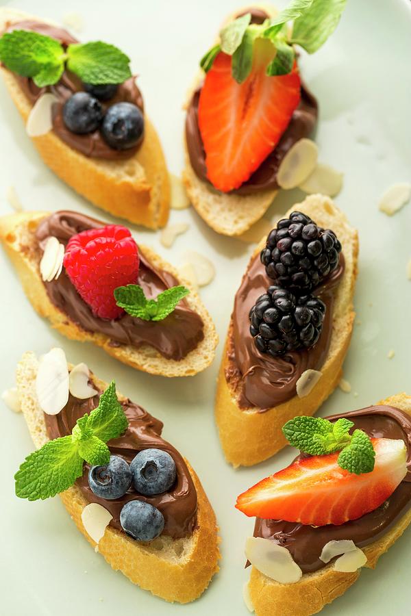 Baguette Slices Topped With Nougat Cream And Berries As Snacks For Children Photograph by Sandra Krimshandl-tauscher