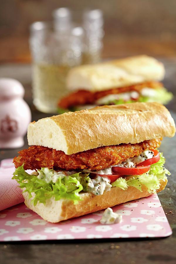 Baguettes With Chicken Schnitzel, Salad, Remoulade Sauce And Tomato Photograph by Teubner Foodfoto
