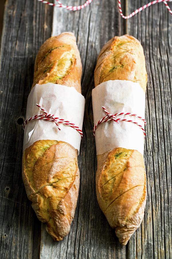 Baguettes With Homemade Herb Butter For A Barbecue Photograph by Sandra Krimshandl-tauscher