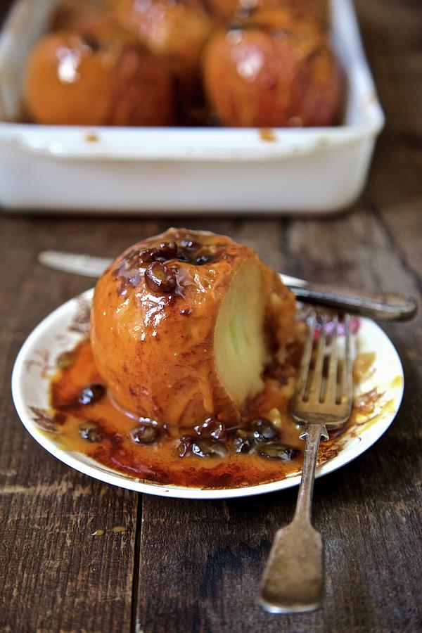 Baked Apples With Caramel Sauce, Cinnamon And Raisins Photograph by Andre Baranowski