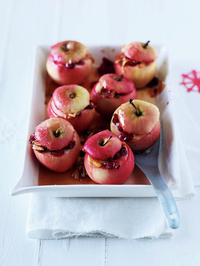 Baked Apples With White Chocolate Sauce, Cranberries And Almonds Photograph by Jalag / Janne Peters