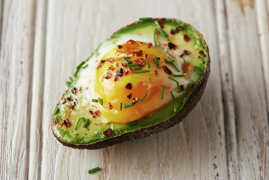 Baked Avocado With An Egg And Chives Photograph by Charlotte Kibbles