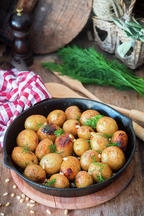 Baked Baby Pototatoes With Pine Nuts Photograph by Irina Meliukh
