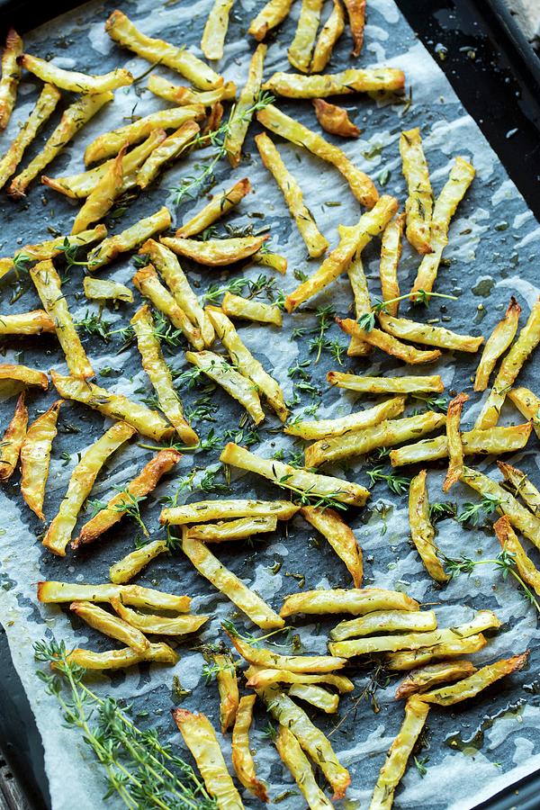 Baked Celeriac Chips On An Oven Tray Photograph by Sandra Krimshandl-tauscher