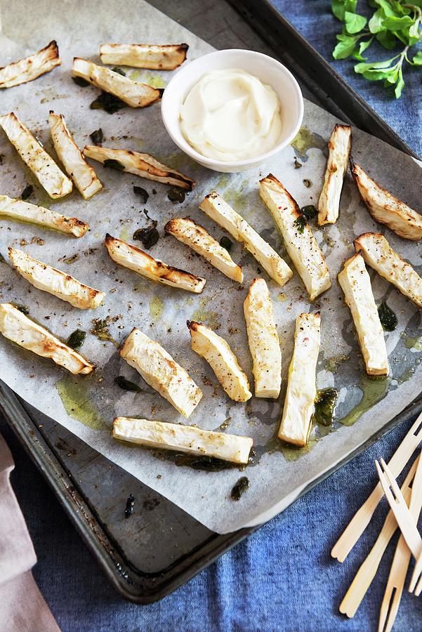 Baked Celery Sticks On A Baking Tray With A Dip Photograph by Veronika Studer