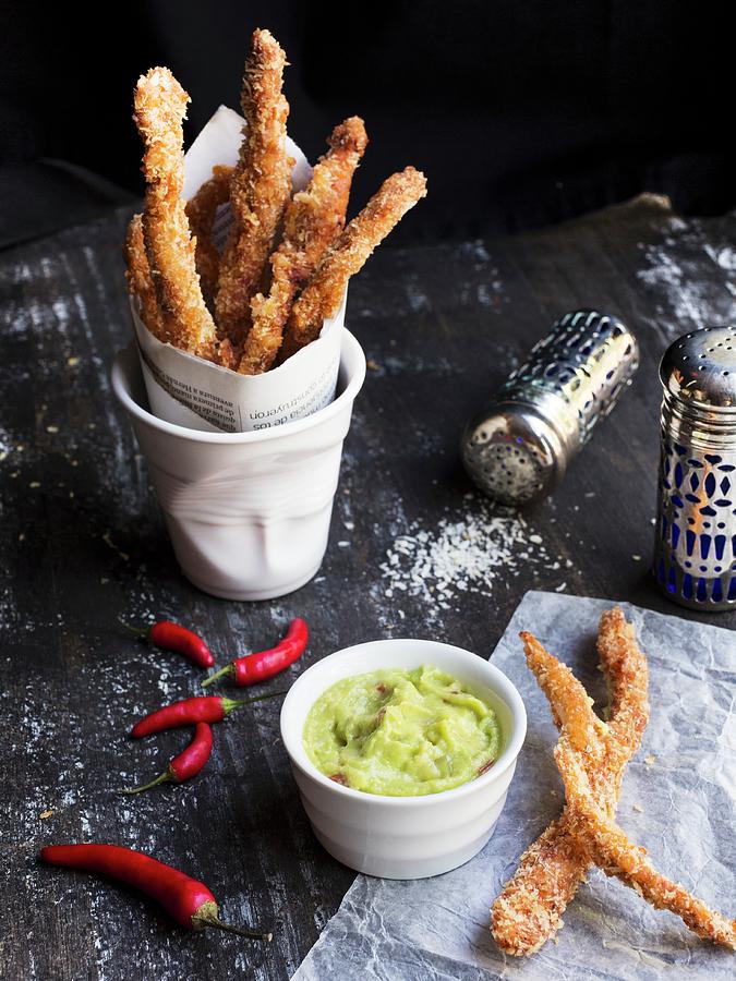 Baked Chicken Sticks In A Cup With Guacamole On A Black Wooden Table Photograph by Taste Agencia Gastronmica