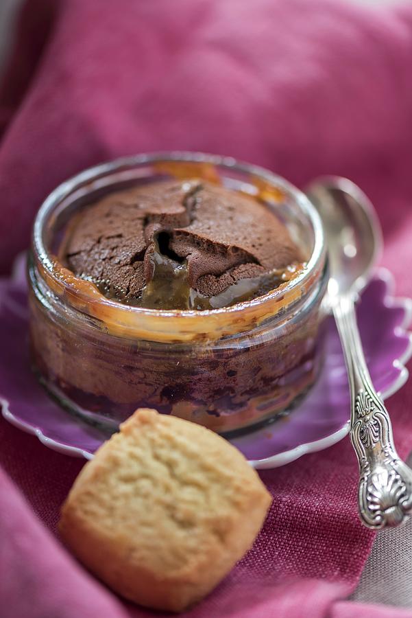 Baked Chocolate Pudding With Salted Caramel Sauce In A Glass Ramekin Photograph by Winfried Heinze