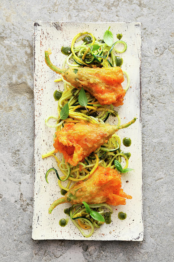 Baked Courgette Flowers Filled With Tomato Polenta On Zoodles Photograph by Jalag / Mathias Neubauer