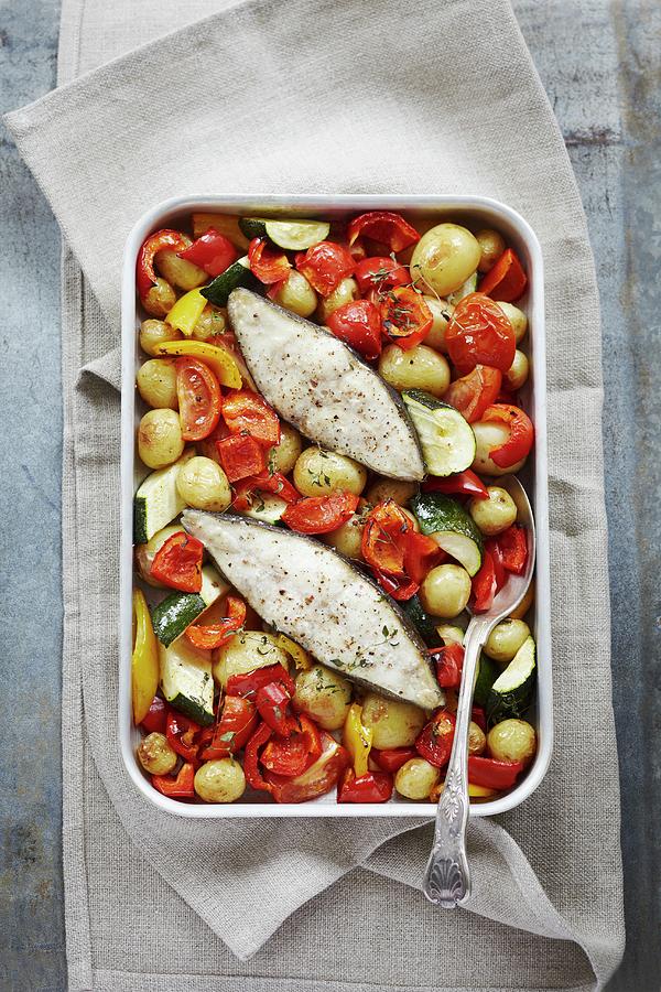 Baked Fish With Tomatoes, Red And Yellow Peppers And Courgettes Photograph by Charlotte Tolhurst