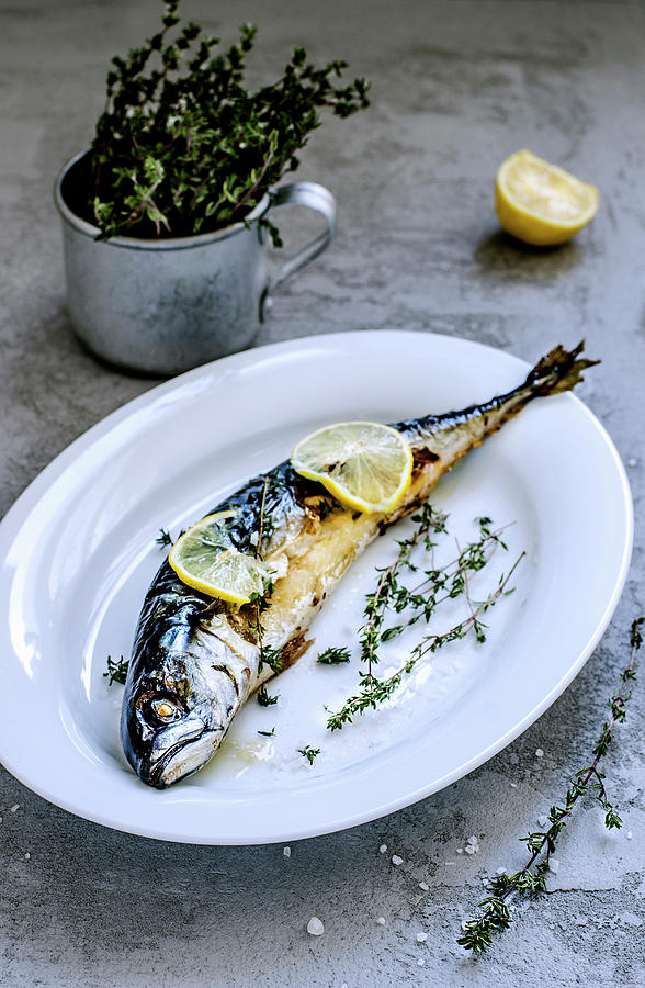 Baked Mackerel Fish With Herbs And Lemon On Beton Surface Photograph by Gorobina