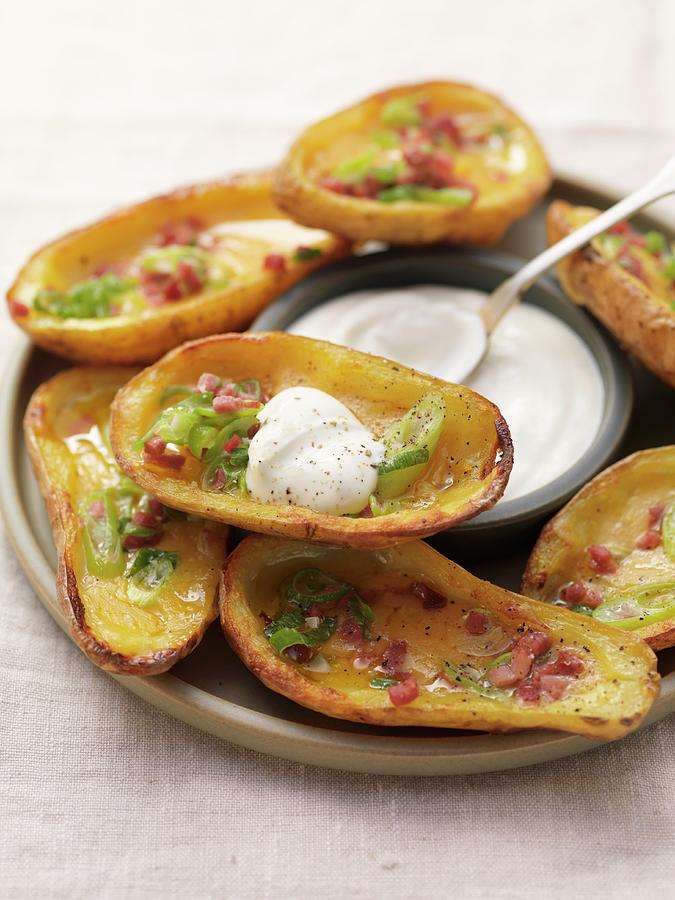 Baked Potato Skins Topped With Bacon, Spring Onions And Sour Cream ...