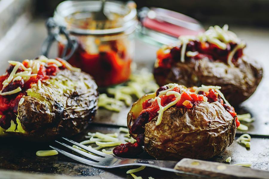 Baked Potatoes With Chili And Grated Cheddar Photograph by Mateusz Siuta