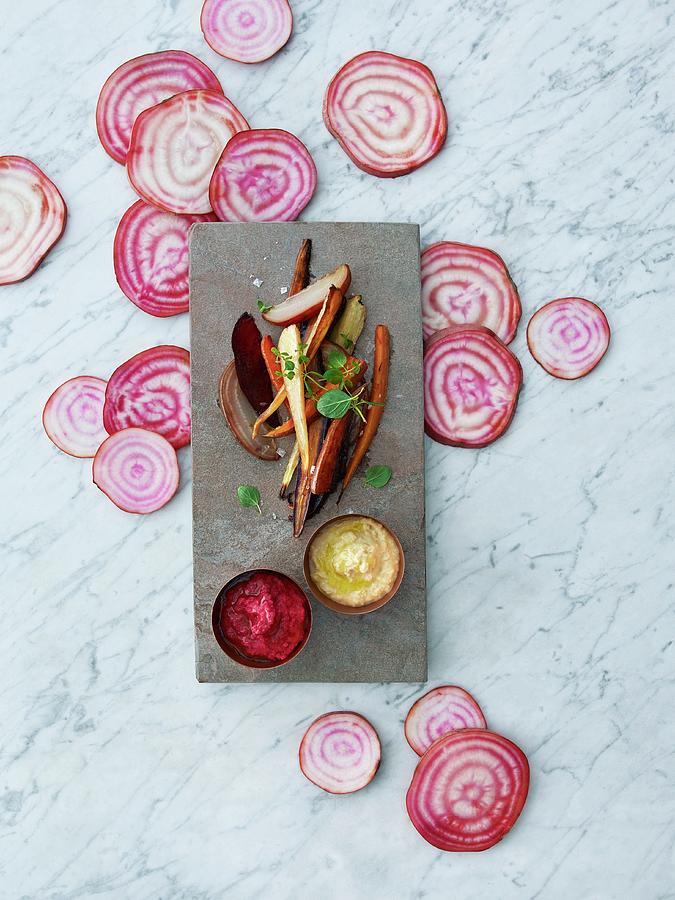 Baked Root Vegetables With Red And Yellow Hummus Photograph by Aina C. Hole