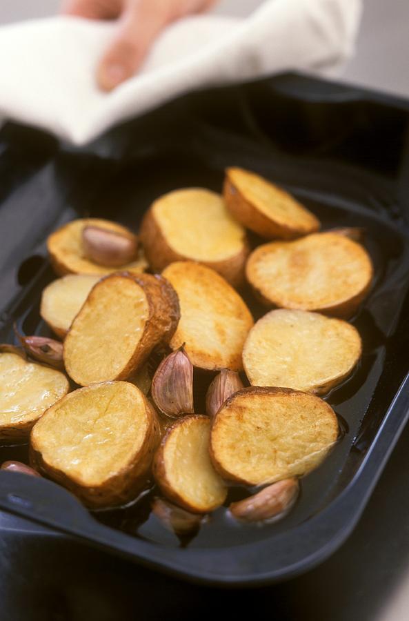 Baked Sweet Potato Slices With Garlic Photograph by William Lingwood
