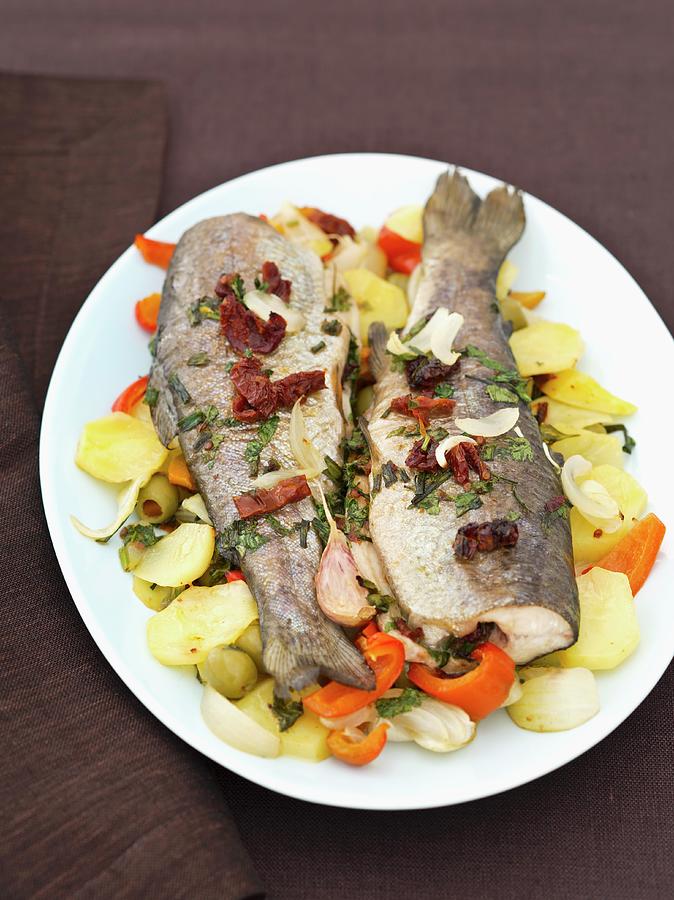 Baked Trout With Herbs, Butter And Vegetables On A Plate Photograph by