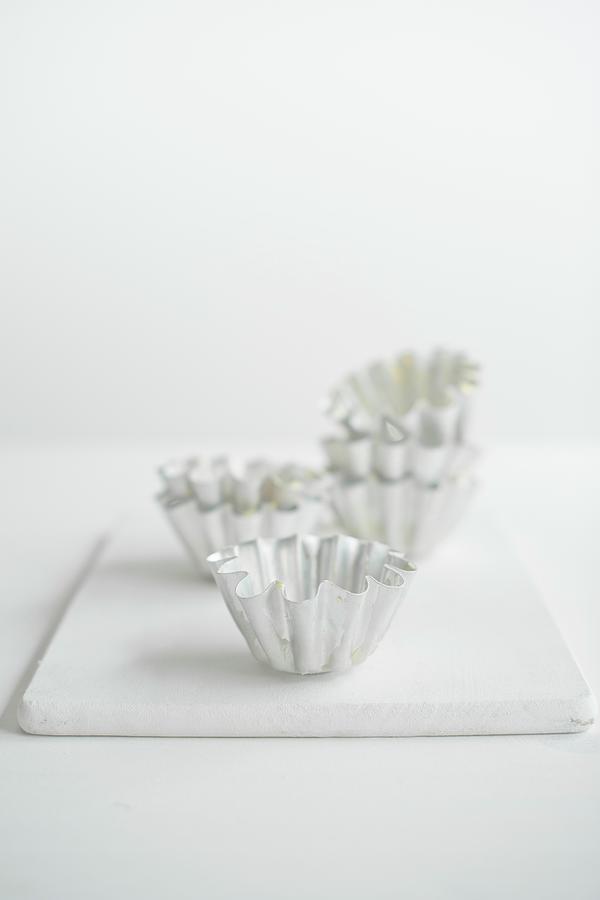 Baking Tins On A White Chopping Board Photograph by Magdalena Hendey