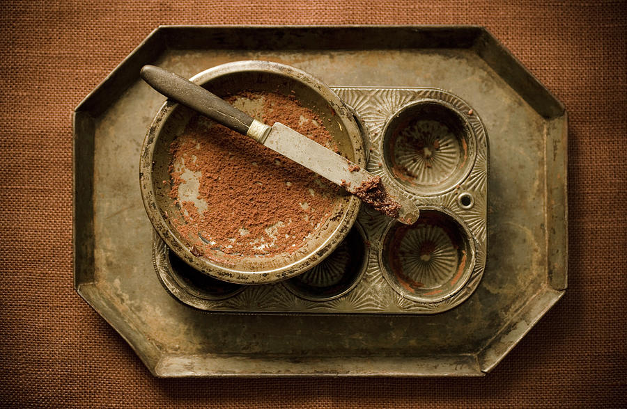 Baking Tins With Chocolate On Knife Photograph by Colin Cooke