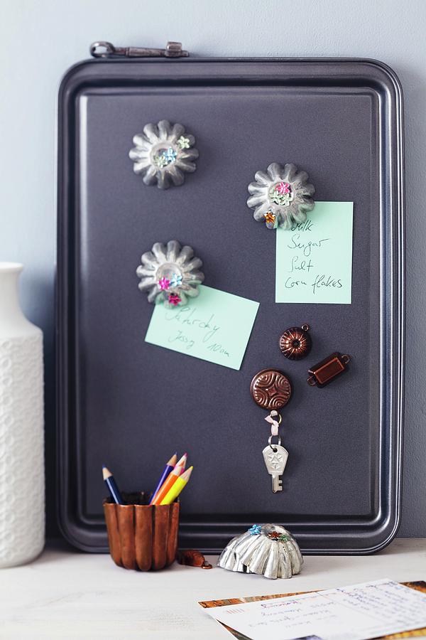 Baking Tray Used As Magnet Pinboard With Magnets Made From Small Cake Moulds & Dolls House Cake Moulds Photograph by Franziska Taube