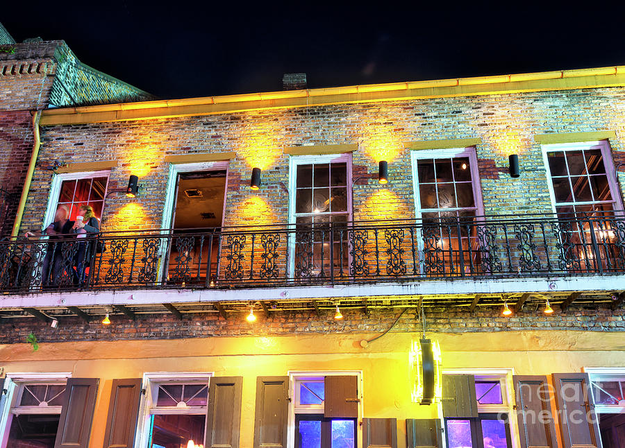 Balcony Couple at Night in New Orleans Photograph by John Rizzuto