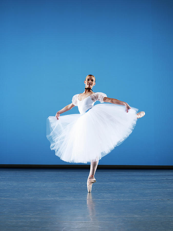 Ballerina Dancing En Pointe On Stage Photograph by Thomas Barwick