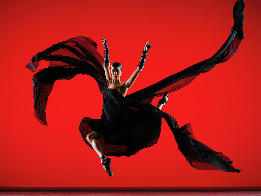 Ballerina Leaping On Stage In Flowing Photograph by Thomas Barwick
