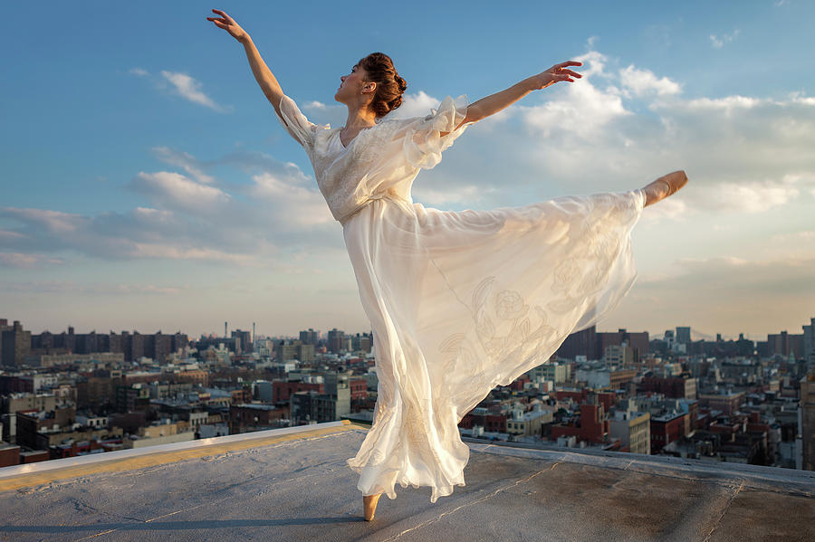 Ballerina Performing Arabesque On Roof Photograph by Nisian Hughes