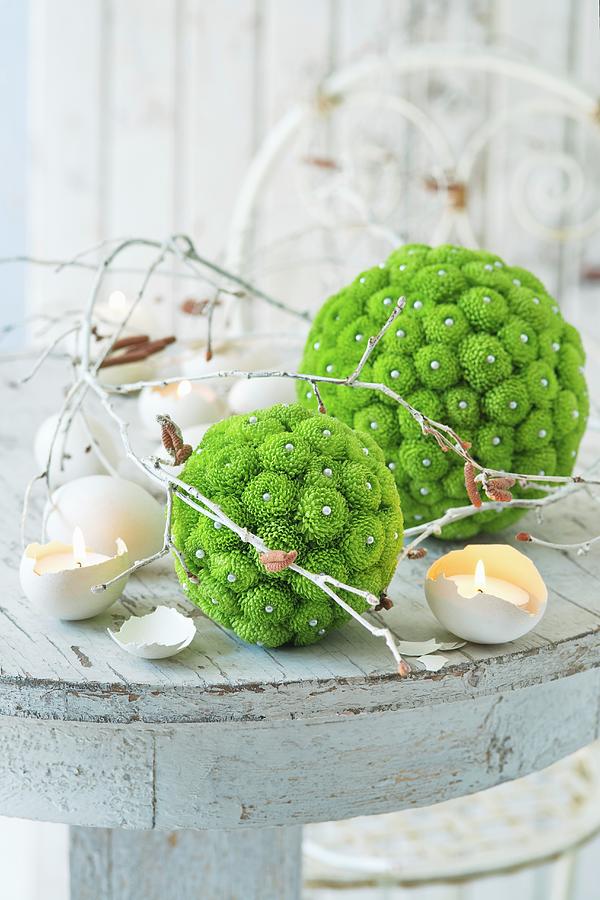 Balls Of Green Flowers, White Branches And Candles In Egg Shells Photograph by Alena Hrbkov