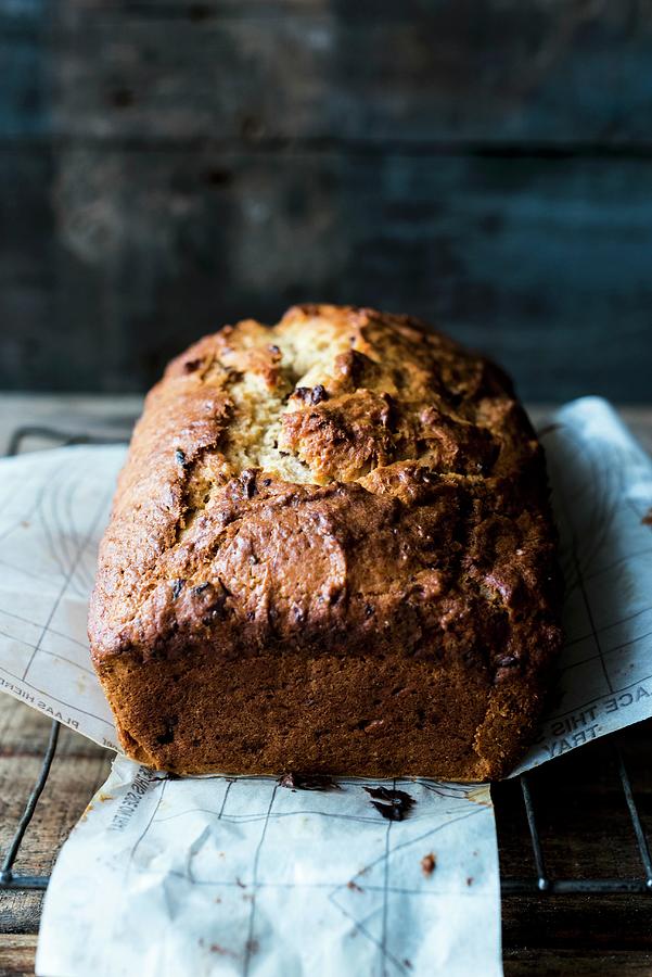 Banana Bread On A Piece Of Baking Paper Photograph by Hein Van Tonder