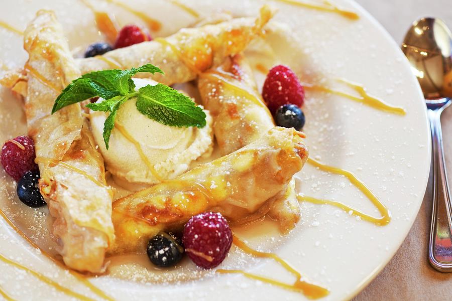Banana-filled Taquitos With Vanilla Ice Cream, Fresh Berries And Caramel Sauce Photograph by Chuck Place