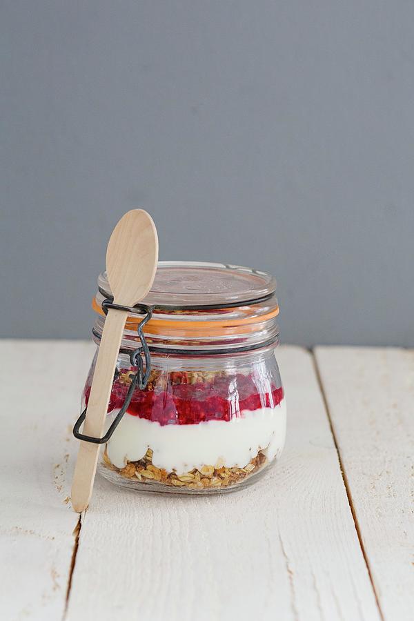 Banana Granola In A Jar With Yoghurt And Raspberry Puree Photograph by Tina Engel