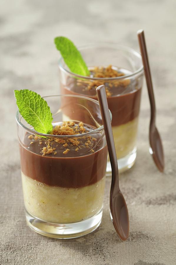 Banana Jelly With Chocolate Sauce In Dessert Glasses Photograph by Jean-christophe Riou