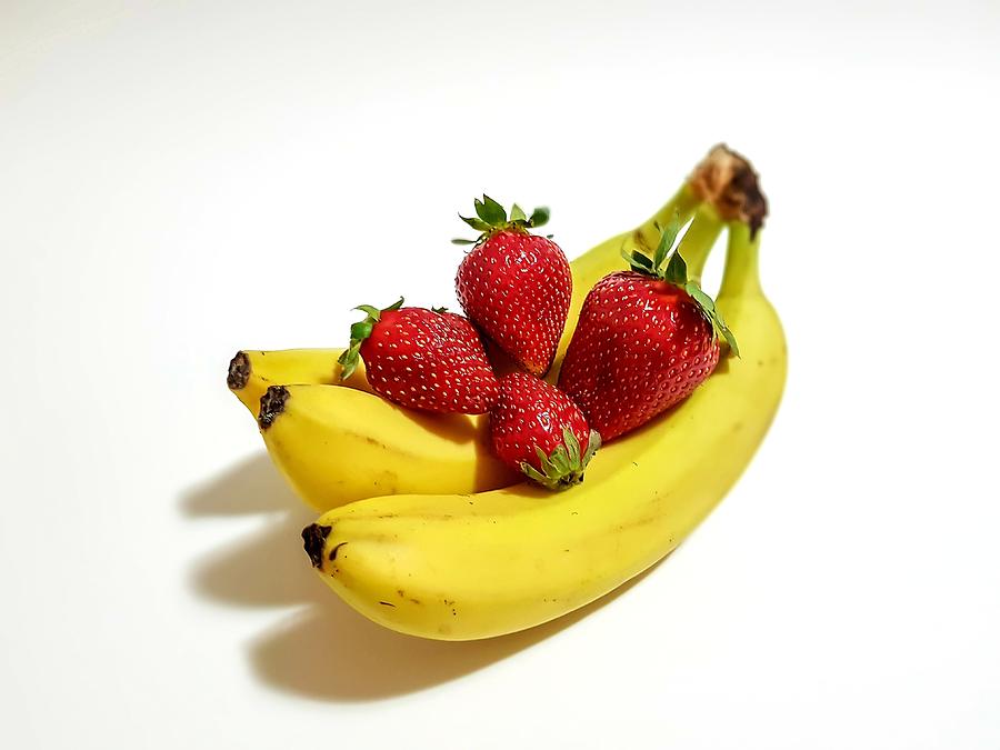 Bananas and strawberries hug Photograph by Dani Solare