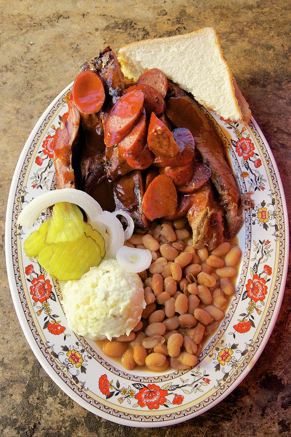 Barbecue Ribs, Sausage With Beans Mashed Potatoes White Bread Onion And Pickle Cucumber, Texas, Usa Photograph by Andre Baranowski