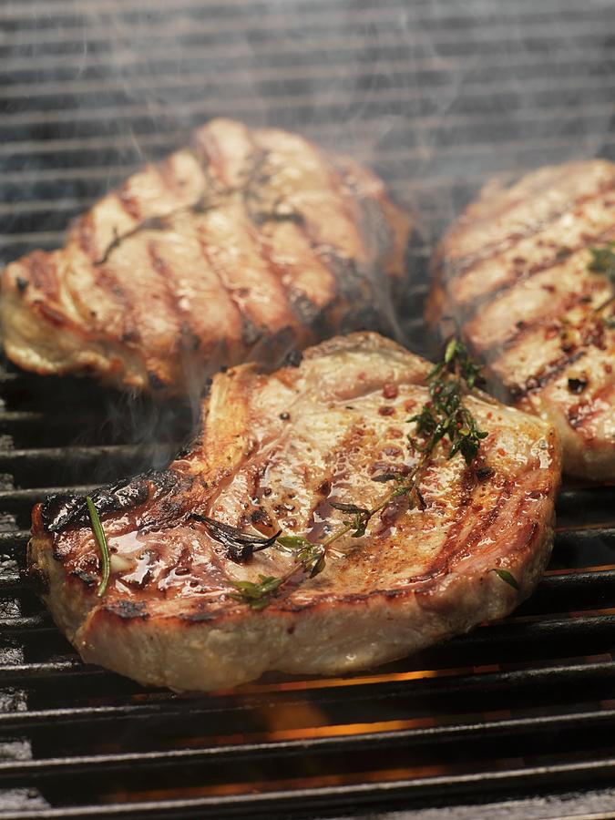 Barbecued Pork Steaks With Herbs On The Barbecue Photograph by Eising ...
