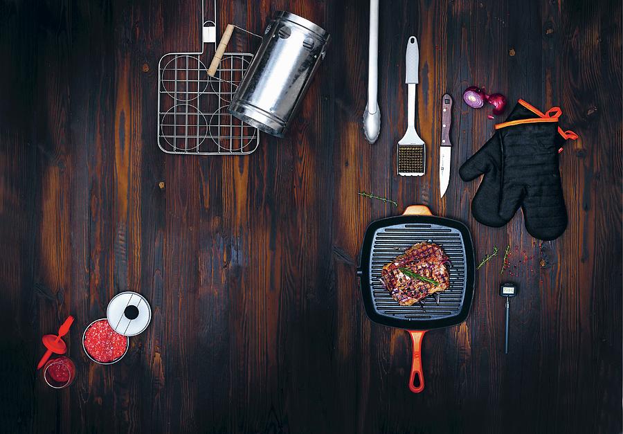 Barbecuing Utensils And Accessories On A Dark Wooden Surface Photograph by Jalag / Michael Bernhardi