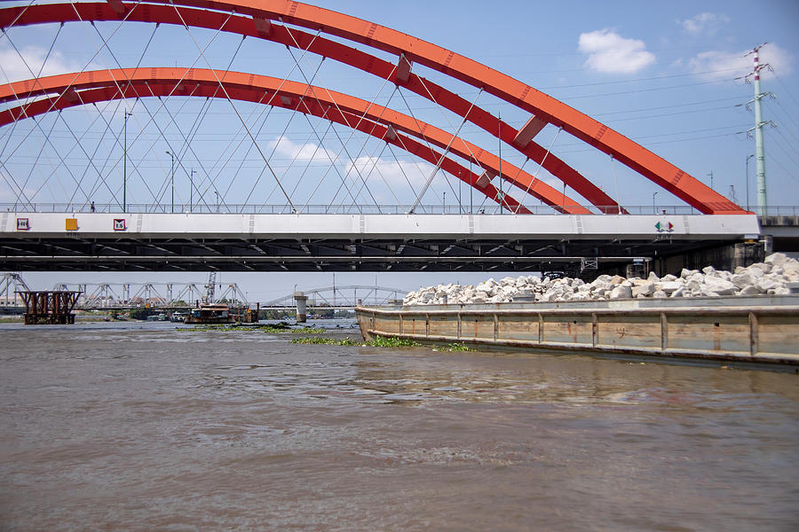 Barge Under Bridge Along Saigon River In Vietnam Photograph