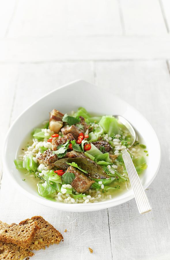 Barley Stew With White Cabbage, Beef, Chilli Peppers And Parsley Photograph by Kai Schwabe