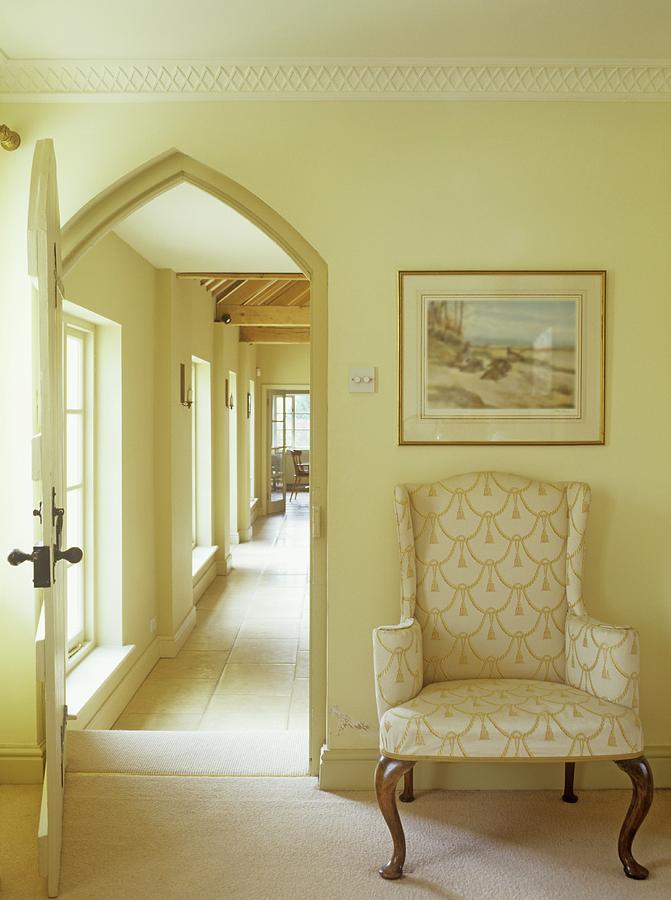 Baroque-style Armchair Next To Open Door With Arched Frame And View Into Corridor Beyond Photograph by Winfried Heinze