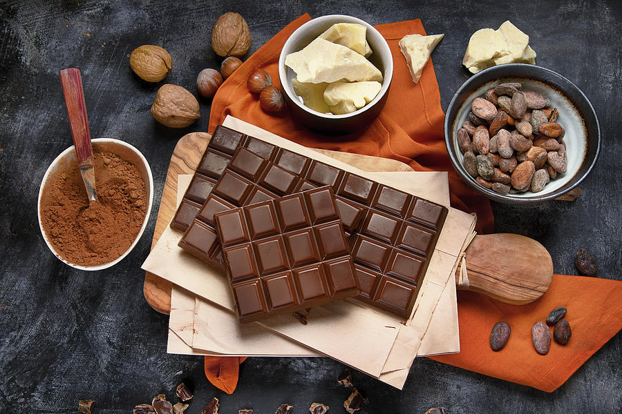 Bars Of Chocolate, Cacao Powder, Cacao Butter And Cacao Beans On Black Background Photograph by Tatjana Baibakova