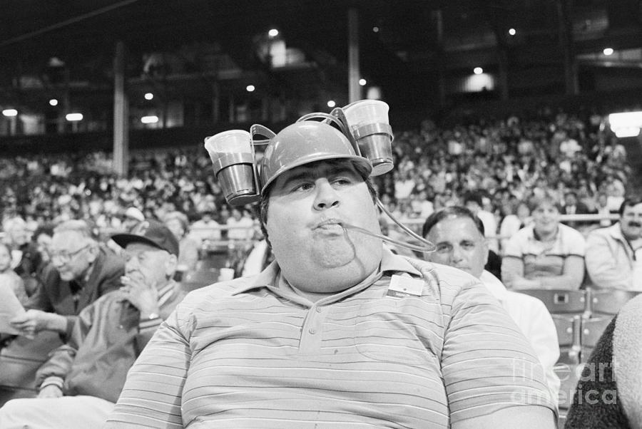 Baseball Fan Drinking From Beer Hat Photograph by Bettmann