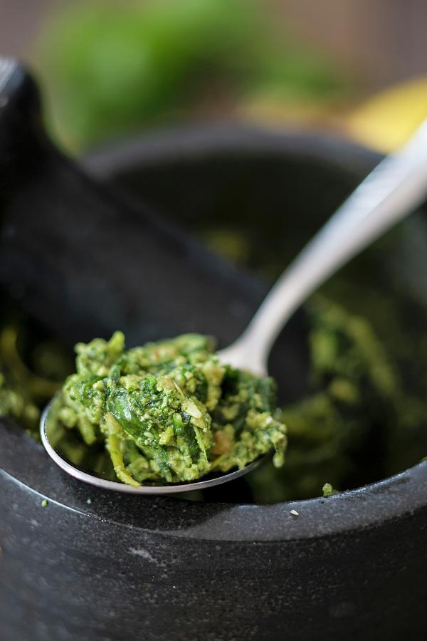 Basil Pesto With Lemon And Walnuts On A Spoon And In A Mortar Photograph by Jan Wischnewski