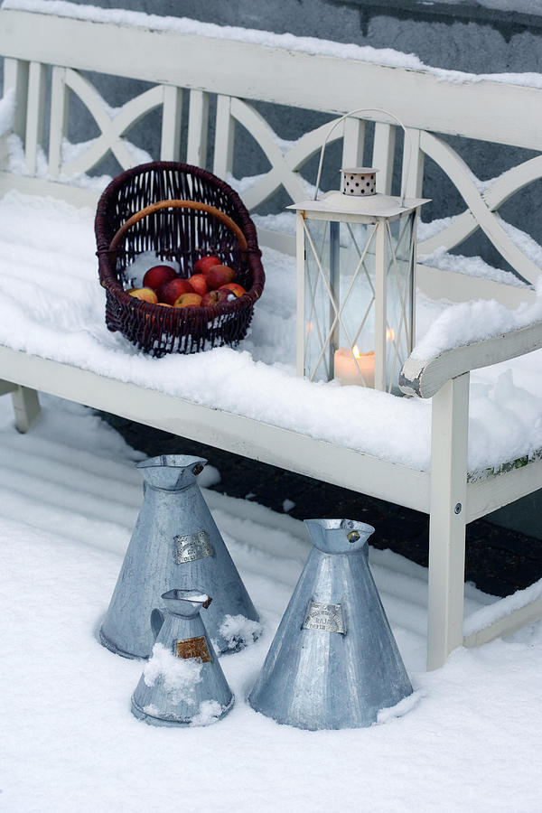 Basket Of Apples And Lantern On White Wooden Bench In Snow Photograph by Kennet House Of Pictures / Havgaard