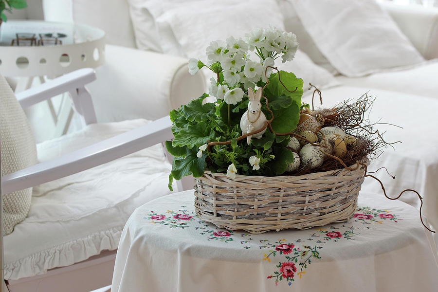 Basket With Primrose, Horned Violets, And Branches As An Easter Decoration With An Easter Bunny And Easter Eggs Photograph by Angelica Linnhoff