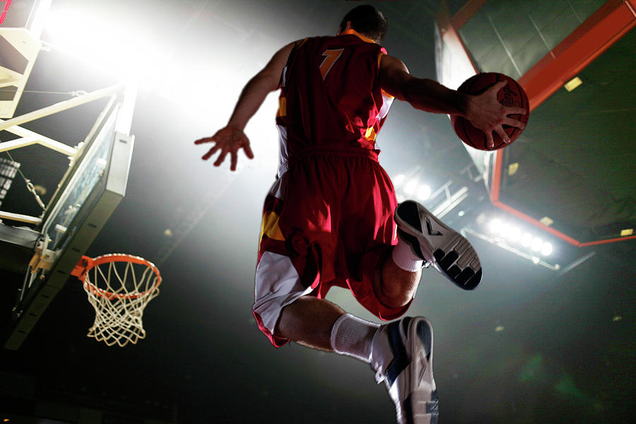 Basketball Player Flies Through Air En Route To A Dunk Photograph by ...