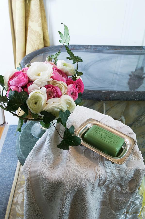 Flowers Still Life Photograph - Bath Towel, Soap And Vase Of Ranunculus In A Bathroom by Christophe Madamour