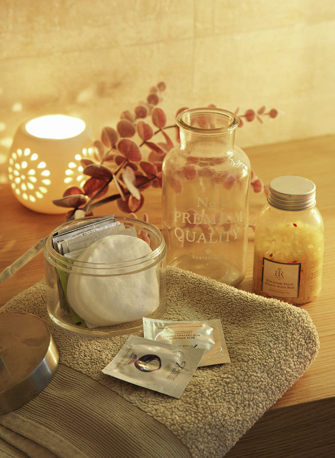 Bathroom Accessories On Towel And Candle Lantern Scattering Warm Light Photograph by Jos-luis Hausmann